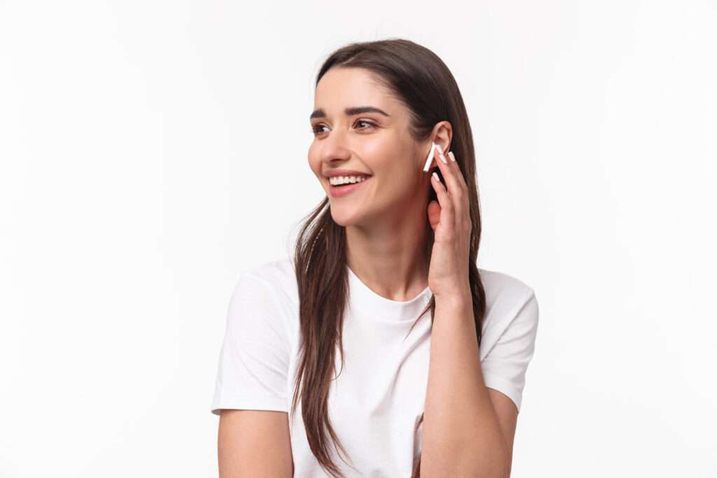 A girl smile while speaking to friends with Airpods